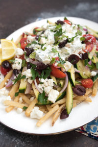 Loaded Mediterranean Fries- Truffle Fries loaded with veggies and Mediterranean flavors like feta, oregano and tzatziki sauce #glutenfree #vegetarian | www.nutritiouseats.com